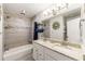 Neutral bathroom with a double vanity, bathtub, shower and modern lighting at 4290 Inverness Ne Ct, Roswell, GA 30075