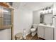 Cozy bathroom featuring modern toilet, vanity, and convenient built-in cabinet for storage at 4290 Inverness Ne Ct, Roswell, GA 30075