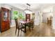 Bright dining room with hardwood floors, modern light fixture, and a large window showcasing the outside view at 4290 Inverness Ne Ct, Roswell, GA 30075