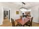 Cozy dining space featuring a decorative light fixture that is open to the living room with stone fireplace at 4290 Inverness Ne Ct, Roswell, GA 30075