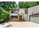 Modern two-story house with a large driveway, wooden deck and tasteful exterior details at 4290 Inverness Ne Ct, Roswell, GA 30075