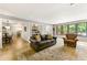 Spacious living room with hardwood floors, ample seating, and a dining area off to the side at 4290 Inverness Ne Ct, Roswell, GA 30075