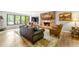 Cozy living room features a stone fireplace, lots of seating, and large windows at 4290 Inverness Ne Ct, Roswell, GA 30075