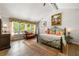 Spacious main bedroom boasts large windows, vaulted ceiling, and decor, creating a serene and luxurious retreat at 4290 Inverness Ne Ct, Roswell, GA 30075