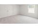 Bright bedroom with plush carpet, closet doors, and a window at 2615 Mourning Dove Drive (Lot 46), Grayson, GA 30017