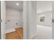 Laundry room featuring hardwood floors, wire shelving, and adjacent bedroom at 2615 Mourning Dove Drive (Lot 46), Grayson, GA 30017