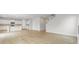 Open-concept living area showcasing the hardwood floors, staircase and view into the kitchen space at 2615 Mourning Dove Drive (Lot 46), Grayson, GA 30017