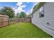 Grassy backyard with wooden fence and gate, offering privacy and outdoor enjoyment at 439 Atlanta Se Ave, Atlanta, GA 30315