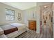 Neutral bedroom with hardwood floors, natural light, dresser and closet view to the hall at 439 Atlanta Se Ave, Atlanta, GA 30315