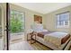 Cozy bedroom featuring vinyl floors and an exterior door to a private deck at 439 Atlanta Se Ave, Atlanta, GA 30315
