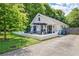 Beautiful white cottage-style home with a patio, landscaping, and private driveway at 439 Atlanta Se Ave, Atlanta, GA 30315