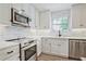 Modern kitchen with stainless steel appliances and white marble countertops and cabinetry at 439 Atlanta Se Ave, Atlanta, GA 30315