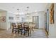 Modern kitchen with white cabinetry, stainless steel appliances, and a dining area with contemporary lighting at 439 Atlanta Se Ave, Atlanta, GA 30315