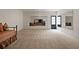 Spacious basement with neutral carpet, a daybed and access to another living space through an expansive opening at 633 Channing Nw Dr, Atlanta, GA 30318