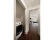 Hallway laundry area, leading to a bedroom with a sloped ceiling, lots of light, and a bed at 633 Channing Nw Dr, Atlanta, GA 30318