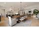 Open concept dining room with hardwood floors, modern lighting, and views into the kitchen and living room at 633 Channing Nw Dr, Atlanta, GA 30318