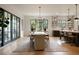 Bright dining room features modern chandelier, light hardwood floors, and a bar with seating at 633 Channing Nw Dr, Atlanta, GA 30318