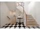 Light-filled entryway features a staircase, black and white tile, and modern accents at 633 Channing Nw Dr, Atlanta, GA 30318