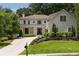 Charming two-story home boasts a landscaped yard and long driveway at 633 Channing Nw Dr, Atlanta, GA 30318