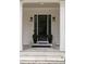 A stylish front door framed by white columns and manicured greenery at 633 Channing Nw Dr, Atlanta, GA 30318