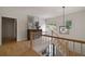 Bright hallway featuring wood floors, natural light, modern light fixture, and stylish decor at 633 Channing Nw Dr, Atlanta, GA 30318