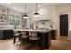 Modern kitchen with stainless steel appliances, pendant lighting, and a large center island with seating at 633 Channing Nw Dr, Atlanta, GA 30318