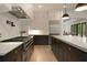 Gourmet kitchen with high-end appliances, stone countertops, and a view into the formal living area at 633 Channing Nw Dr, Atlanta, GA 30318