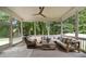 Covered screened porch featuring comfortable seating and a view of a wooded backyard at 633 Channing Nw Dr, Atlanta, GA 30318
