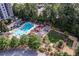 Aerial view showcases the pool, barbecue area, and playground surrounded by trees at 795 Hammond Dr # 808, Sandy Springs, GA 30328