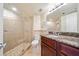 Modern bathroom featuring tiled shower, granite counters, and large mirror at 795 Hammond Dr # 808, Sandy Springs, GA 30328