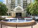 Attractive high-rise building featuring a lovely water fountain, tasteful landscaping, and a covered entry at 795 Hammond Dr # 808, Sandy Springs, GA 30328