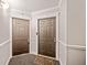 This building hallway provides secure access to individual units with well-lit corridors and dark doors at 795 Hammond Dr # 808, Sandy Springs, GA 30328