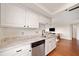 Galley kitchen with granite countertops and stainless appliances with hardwood floors at 795 Hammond Dr # 808, Sandy Springs, GA 30328