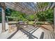 Outdoor kitchen area with a built-in grill, stone counter, and wooden pergola at 795 Hammond Dr # 808, Sandy Springs, GA 30328