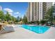 Large, sparkling swimming pool with lounge chairs and well-maintained landscaping at 795 Hammond Dr # 808, Sandy Springs, GA 30328