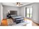 Clean bedroom featuring a bed, sleek furnishings, hardwood floors, and a bright window at 903 Tuxworth Cir, Decatur, GA 30033