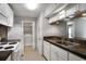 Functional kitchen with sleek countertops, white appliances, and convenient laundry area at 903 Tuxworth Cir, Decatur, GA 30033