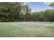 Outdoor tennis court surrounded by mature trees, providing a scenic and active recreation space at 903 Tuxworth Cir, Decatur, GA 30033