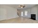 Bright living room features a fireplace, ceiling fan and light wood flooring at 132 Felicity Pike, Locust Grove, GA 30248