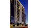 Elegant high-rise condo building featuring private balconies and modern architectural design against a twilight sky at 2425 Peachtree Ne Rd # 1505, Atlanta, GA 30305