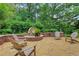 Charming backyard patio with stone fountain, brick accents, and comfortable seating area at 3467 Brookleigh Ne Ln, Atlanta, GA 30319