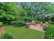 Landscaped backyard with lush greenery and stone patio, creating a serene outdoor retreat at 3467 Brookleigh Ne Ln, Atlanta, GA 30319