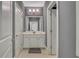 Hallway bathroom features one sink, a tiled floor, gray walls and a three bulb ceiling mounted light at 3467 Brookleigh Ne Ln, Atlanta, GA 30319