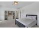 Bright bedroom with built-in bookshelves and neutral decor, illuminated by a modern ceiling fan with lights at 3467 Brookleigh Ne Ln, Atlanta, GA 30319