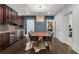 Dining room with modern table, stylish chandelier, and wine fridge built into the dark wood cabinets at 3467 Brookleigh Ne Ln, Atlanta, GA 30319