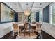 Dining room with wainscoting, modern light fixture, and bright windows at 3467 Brookleigh Ne Ln, Atlanta, GA 30319
