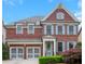 Charming two-story brick home with a two-car garage, manicured lawn, and inviting front entrance at 3467 Brookleigh Ne Ln, Atlanta, GA 30319