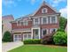 Charming two-story brick home featuring a well-manicured lawn and an attached two-car garage at 3467 Brookleigh Ne Ln, Atlanta, GA 30319