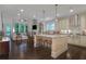 Open-concept kitchen with island seating, stainless steel appliances, and seamless flow to the living area at 3467 Brookleigh Ne Ln, Atlanta, GA 30319