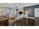 Spacious living room with dark hardwood floors, built-in shelving, a ceiling fan, and abundant natural light at 3467 Brookleigh Ne Ln, Atlanta, GA 30319